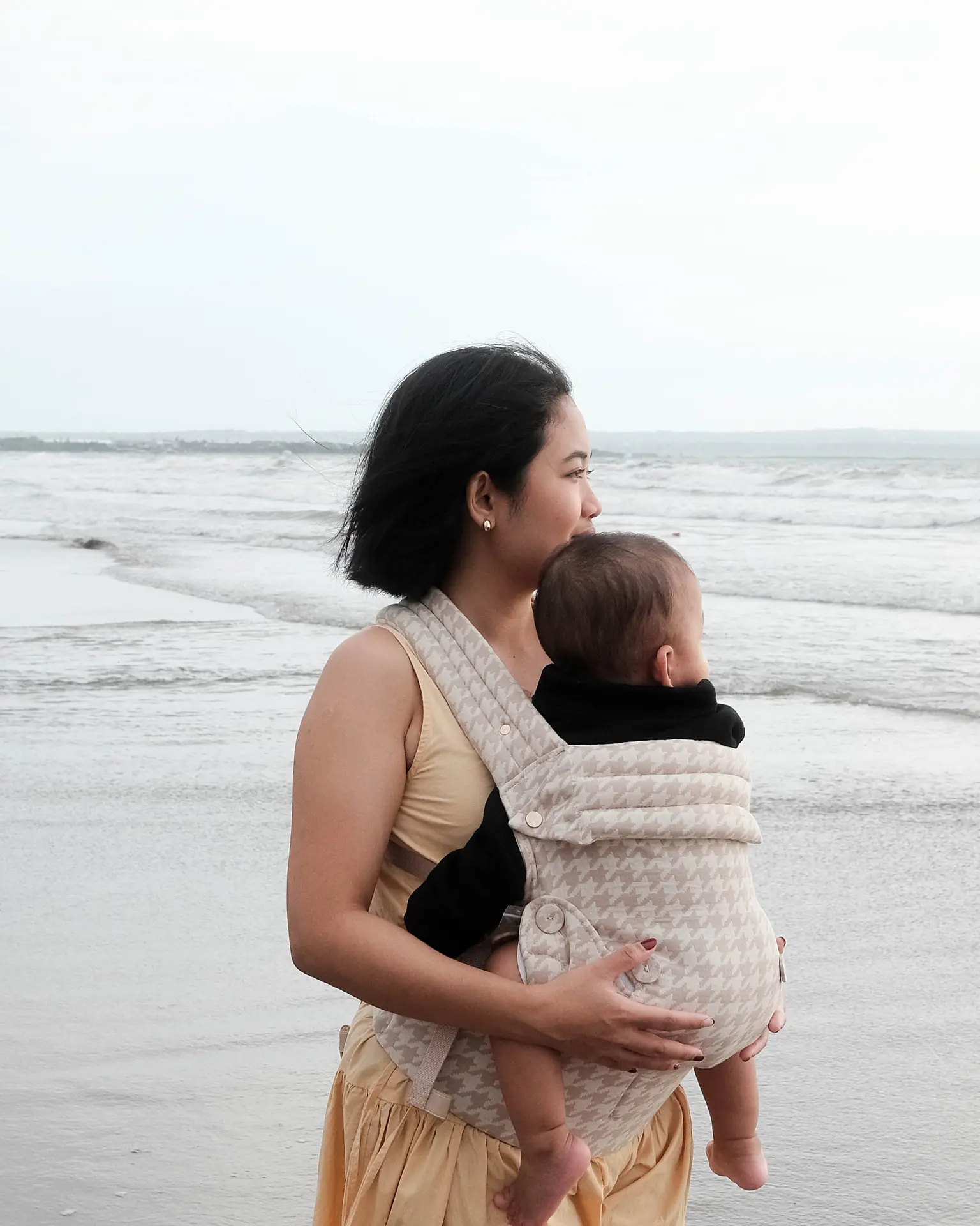 Parent using baby carrier outdoors
