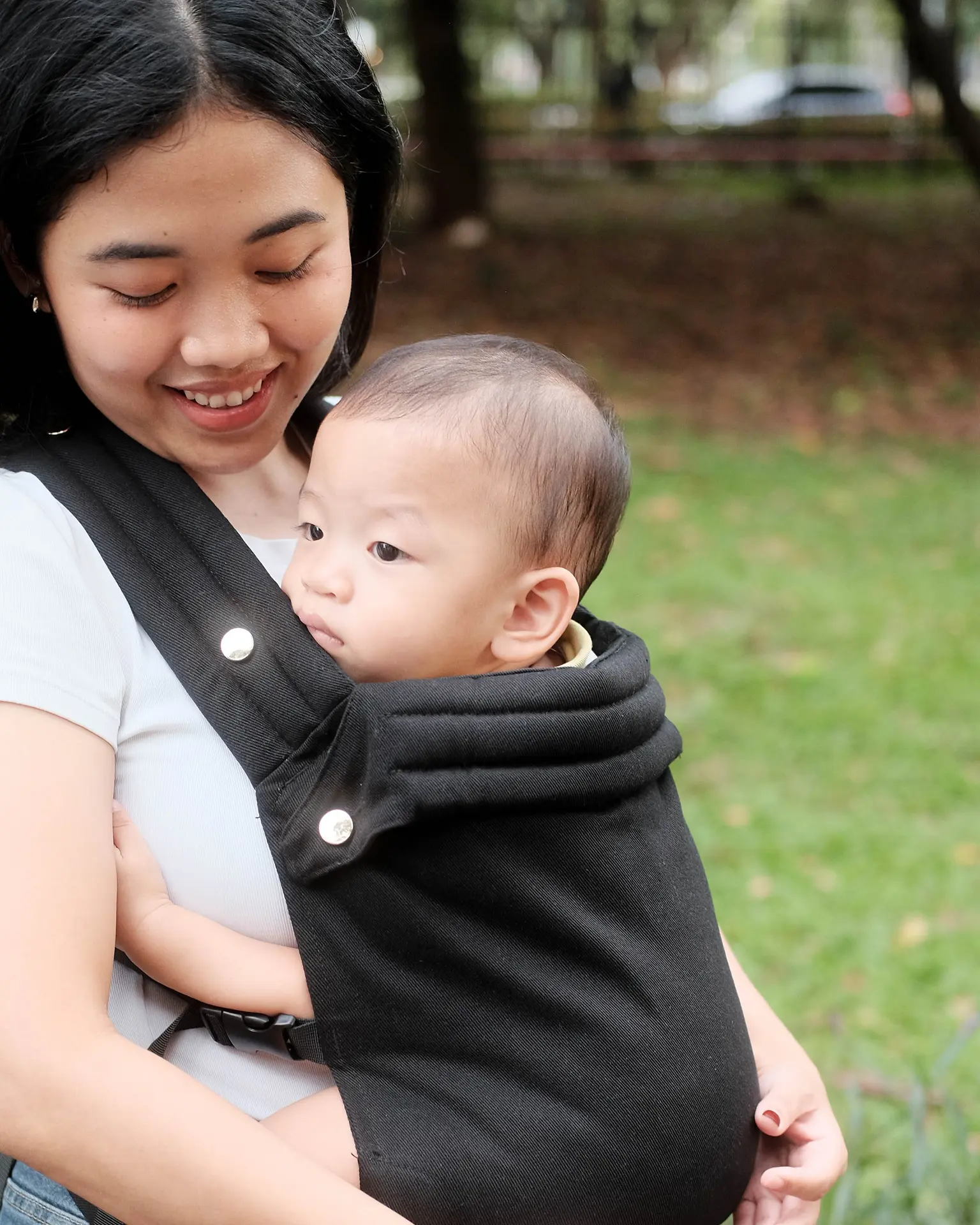Happy parent with baby carrier